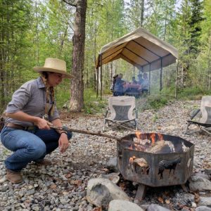 Wrangler cooking s'mores over the fire at the Cowboy Cookout in West Glacier, near Glacier National Park